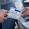 Guy renting a car paying with credit car